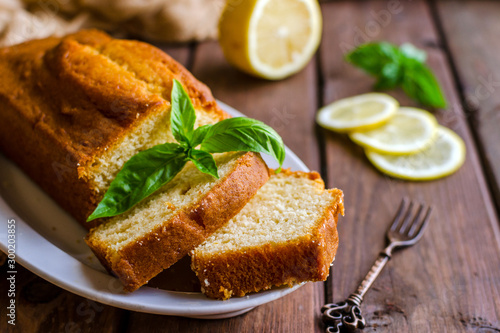 Photography Lemon pound cake on rustic wooden background with lemon.