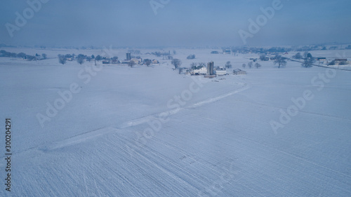 Aerial View of Fresh Followed Morning Snow over an Amish Countryside and Farm Land as Seen by a Drone © Greg Kelton