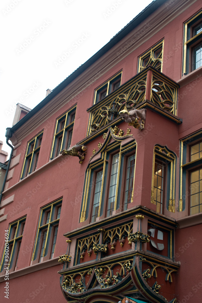 Naklejka premium Freiburg im Breisgau, Germany - November 13, 2018: The famous red facade of the Historical Merchants' Hall (Historisches Kaufhaus in german), situated on the Minster Square.
