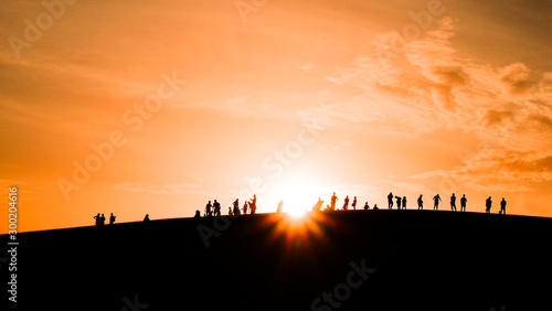 Fototapeta Naklejka Na Ścianę i Meble -  Sillhouette image of sunset at hill in the evening