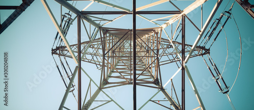 Tablou canvas Close up of electrical tower and blue sky