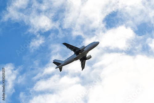 Passenger airliner flight in the blue sky. Travel concept.