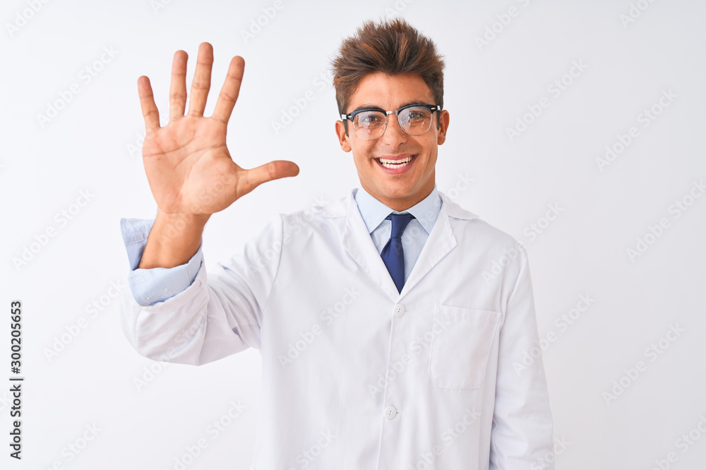 Young handsome sciencist man wearing glasses and coat over isolated white background showing and pointing up with fingers number five while smiling confident and happy.