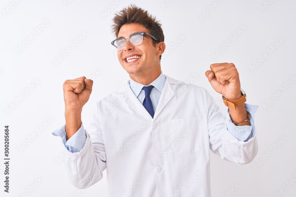 Young handsome sciencist man wearing glasses and coat over isolated white background celebrating surprised and amazed for success with arms raised and eyes closed. Winner concept. Young handsome sciencist man wearing glasses and coat over isolated white background celebrating surprised and amazed for success with arms raised and eyes closed. Winner concept.