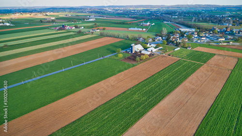 Aerial View of Amish Farms and Countryside on a Spring Day with Green and Brown Fields as Seen by a Drone