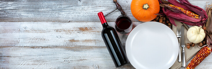 White dinner table decorated for Thanksgiving dinner celebration with plenty of copy space