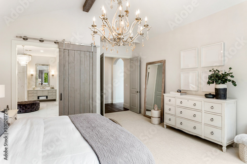 Beautiful master bedroom in new luxury home with view of ensuite bathroom. photo