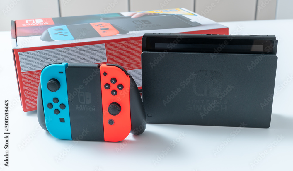 Nintendo Switch video game console developed by Nintendo, released on March  3, 2017 on a white background. Germany, Berlin - June 30, 2019: Nintendo  Switch Joy-con controller on a white background foto