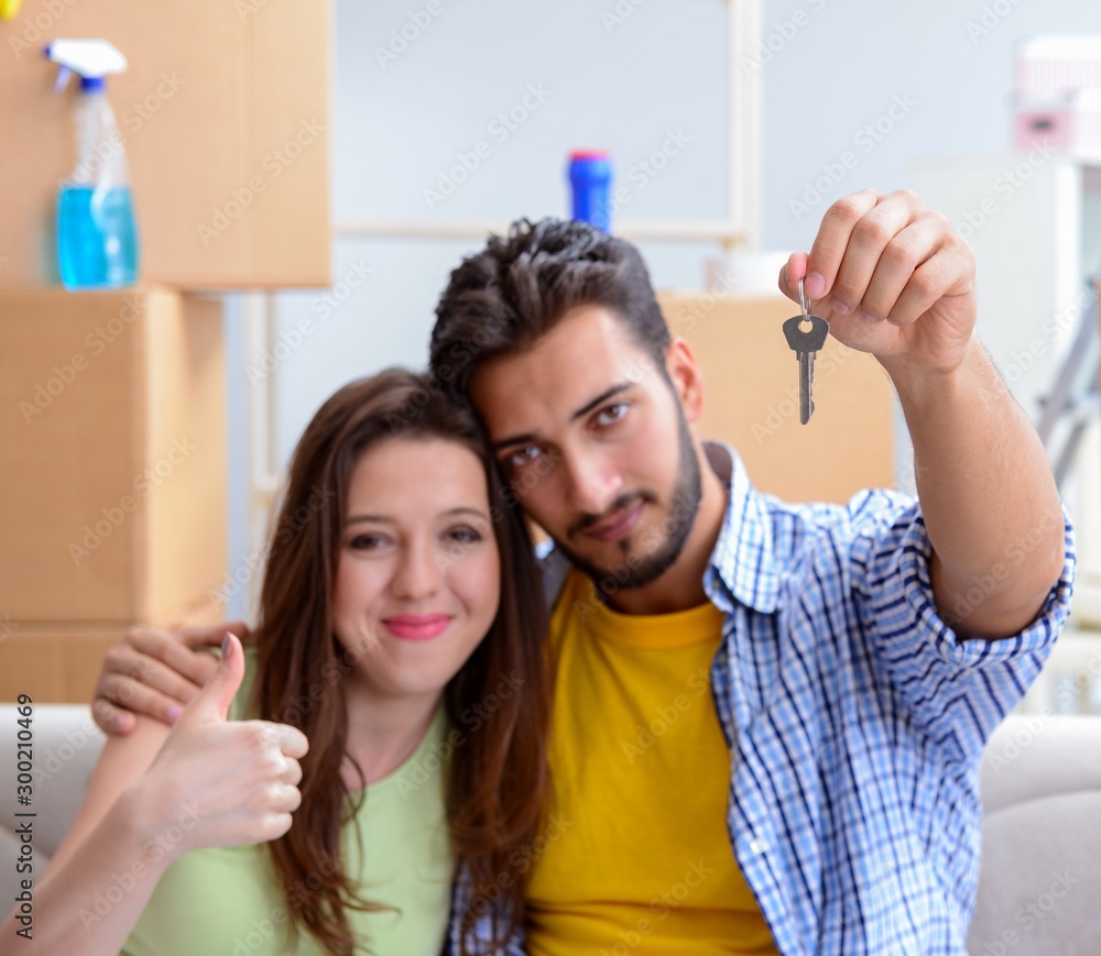 Young pair moving in to new apartment under mortgage Young pair moving in to new apartment under mortgage