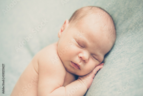 Cute newborn baby sleeping without clothes. Close up