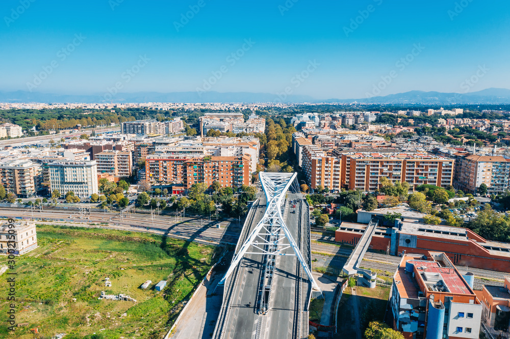 Obraz premium White metal bridge over railroad in one of districts of Rome, Italy, aerial view from drone.