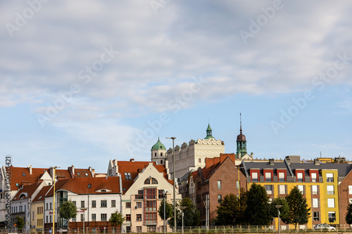 Colorful buildings in the city. Clouds above them