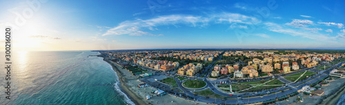 Ostia beach aerial view from drone. Ostia Lido near Rome, Italy. Beautiful sea, coast and city view at sunset from above.