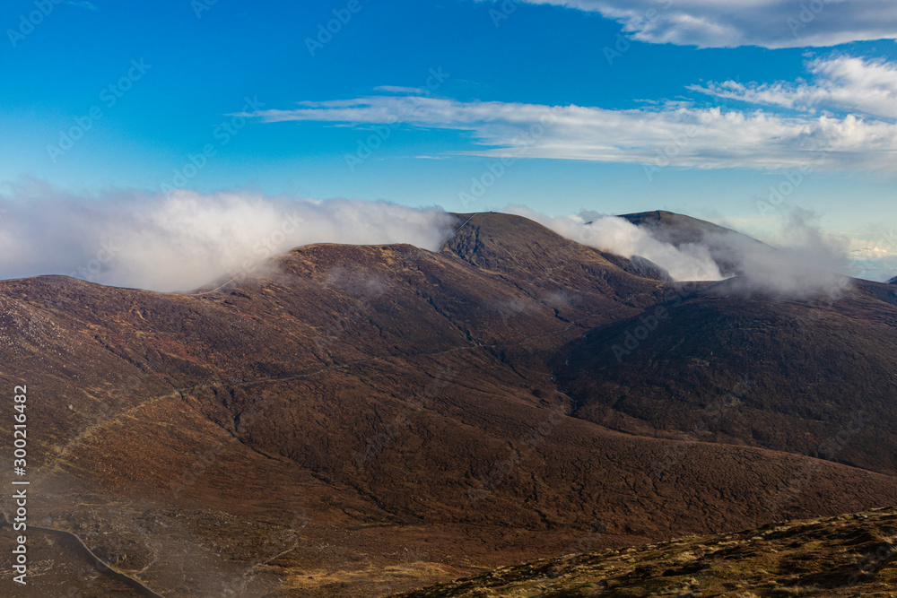 Mourne Mountains, Slievenaglogh, Commedagh and Donard, with bright white sunlit  mist settling around them