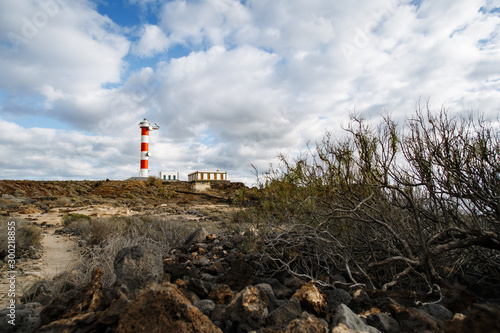 Punta Abona lighthouse. Landscape overlooking the ocean. Sunset. The water is shiny. Tenerife Island, Spain photo