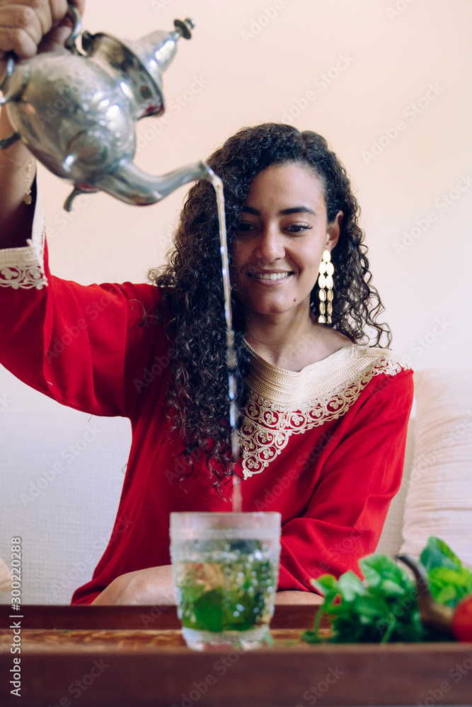 Moroccan green herbal tea poured with silver teapot in traditional ways