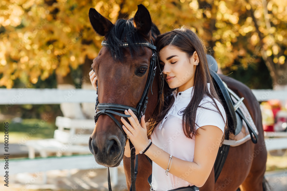 Obraz premium Smart animal. Happy woman with her horse on the ranch at daytime.