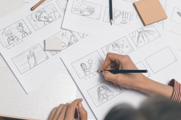 Hands draw a storyboard for the film.