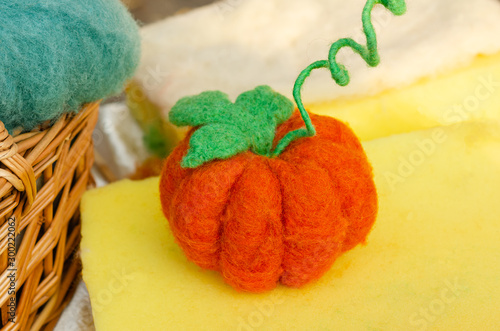 Halloween orange pumpkin made of felt. Halloween hand crafted jack o'lantern for home decorating 