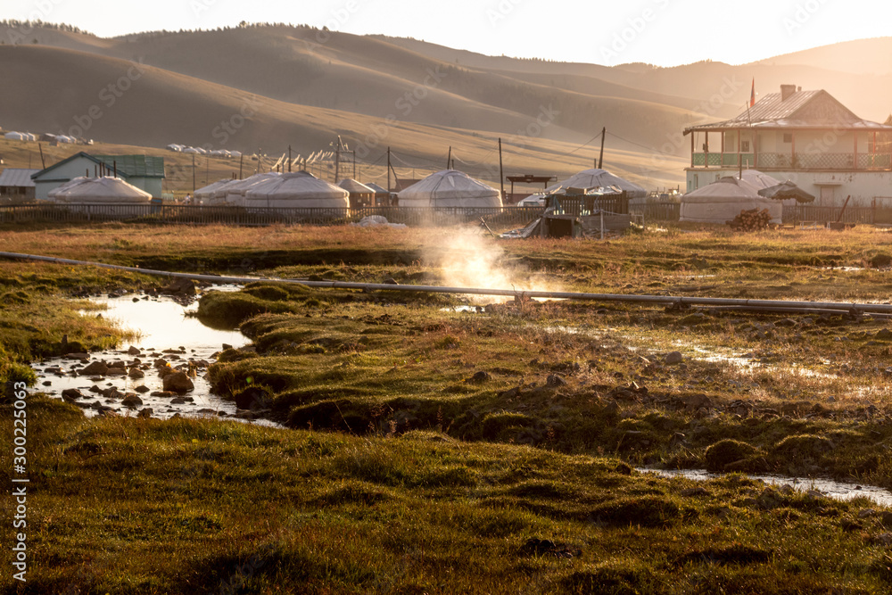 Fototapeta premium Tsenher Hot Springs in Mongolia, with steam coming out from the very soil.