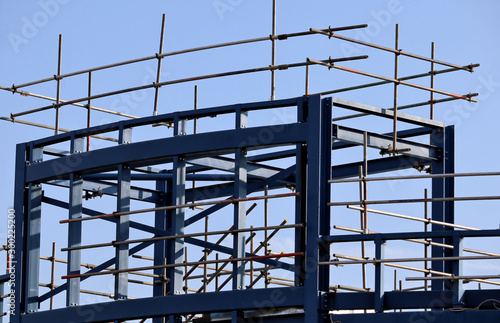 modern office building under construction with scaffolding