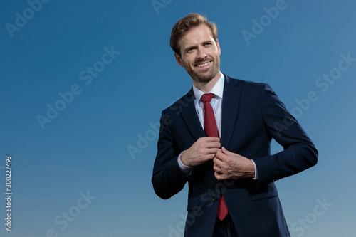 Positive businessman about to take out a surprise and laughing