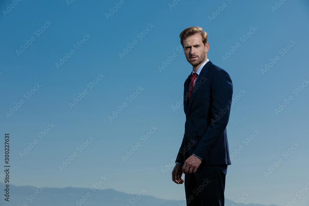 Motivated businessman looking to the camera and frowning Motivated businessman looking to the camera and frowning