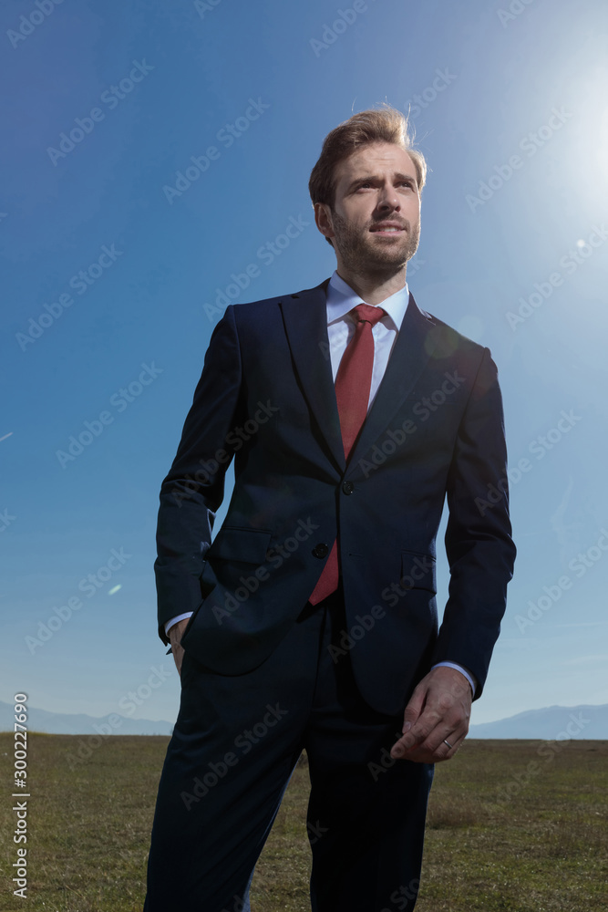 Hopeful businessman looking away while standing