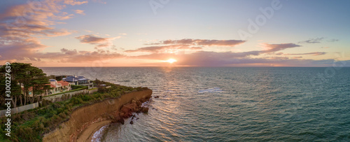 Aerial panoramic seascape of luxury houses on a cliff at sunset photo