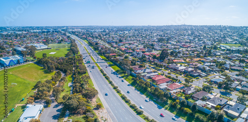 Cars driving on Monash freeway through Wheelers Hill suburb in Melbourne, Australia on sunny day - aerial panorama