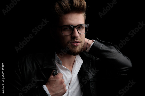 casual man wearing eyeglasses with one hand behind his head
