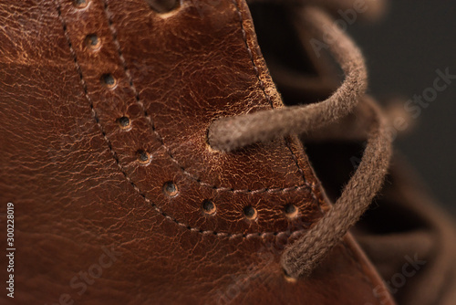 Vintage brown boots on black background, detail of retro shoes