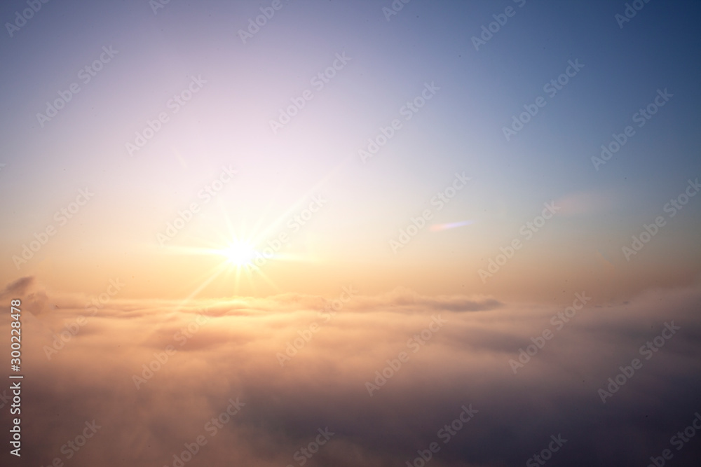 clear sky with large fog, orange dawn over the clouds of air