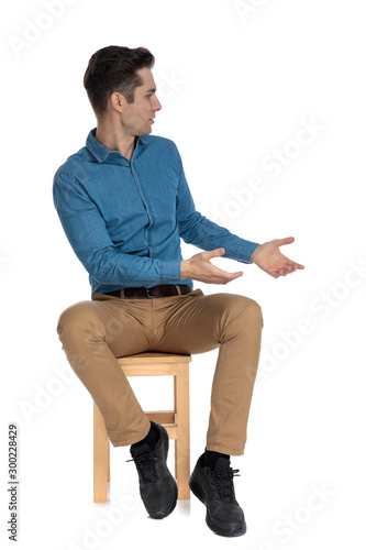 smart casual man in blue shirt talking to side