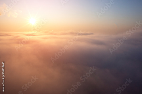 clear sky with large fog, orange dawn over the clouds of air