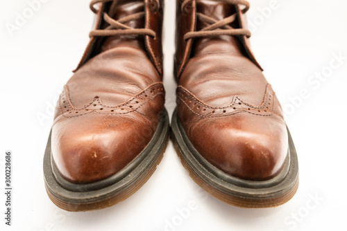 Vintage brown boots on white background, retro shoes