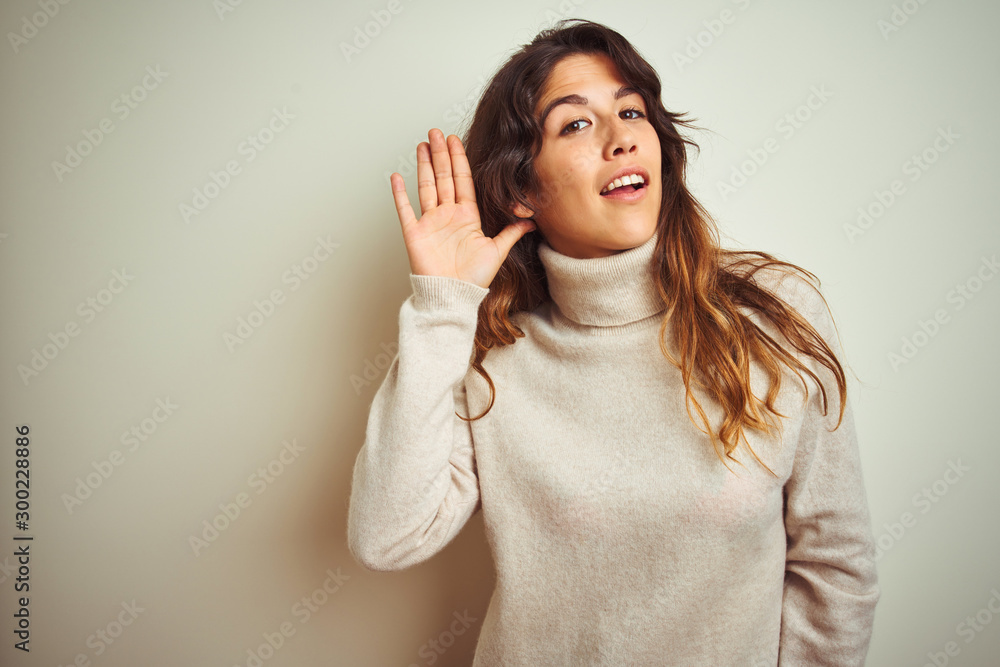 Young beautiful woman wearing winter sweater standing over white isolated background Waiving saying hello happy and smiling, friendly welcome gesture Young beautiful woman wearing winter sweater standing over white isolated background Waiving saying hello happy and smiling, friendly welcome gesture