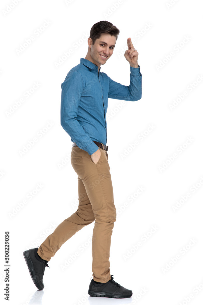 side view of smart casual man smiling and military saluting side view of smart casual man smiling and military saluting