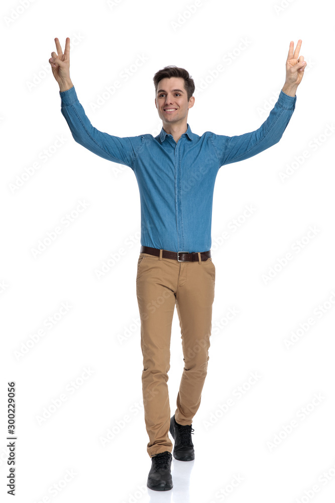 happy young man smiling and making peace sign happy young man smiling and making peace sign