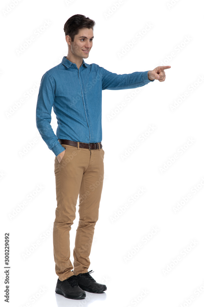 happy young model pointing finger and smiling happy young model pointing finger and smiling