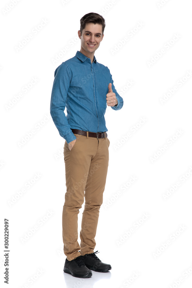 smart casual man making thumbs up sign and smiling smart casual man making thumbs up sign and smiling