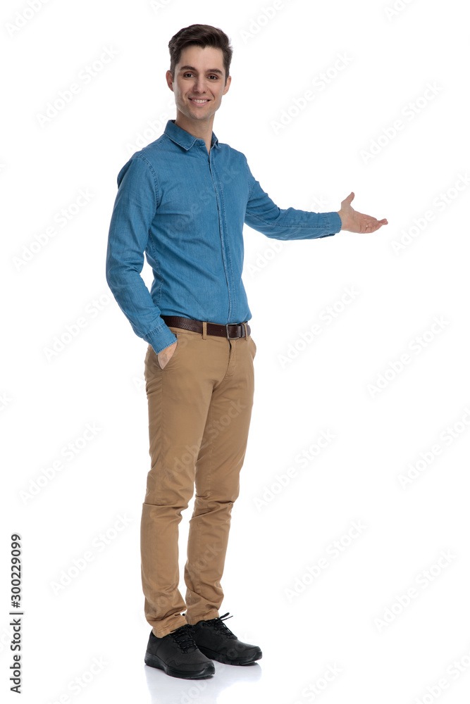 happy fashion man smiling and presenting to side happy fashion man smiling and presenting to side
