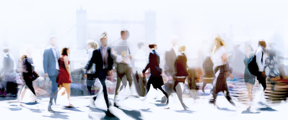Walking people blur. Lots of people walking in the City of London. Wide panoramic view of people crossing the road. 