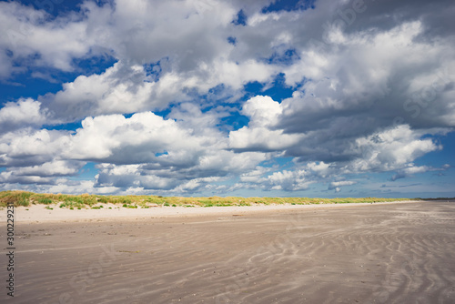 Photography Ireland Dublin beach dune grass landscape with blue sky and clouds