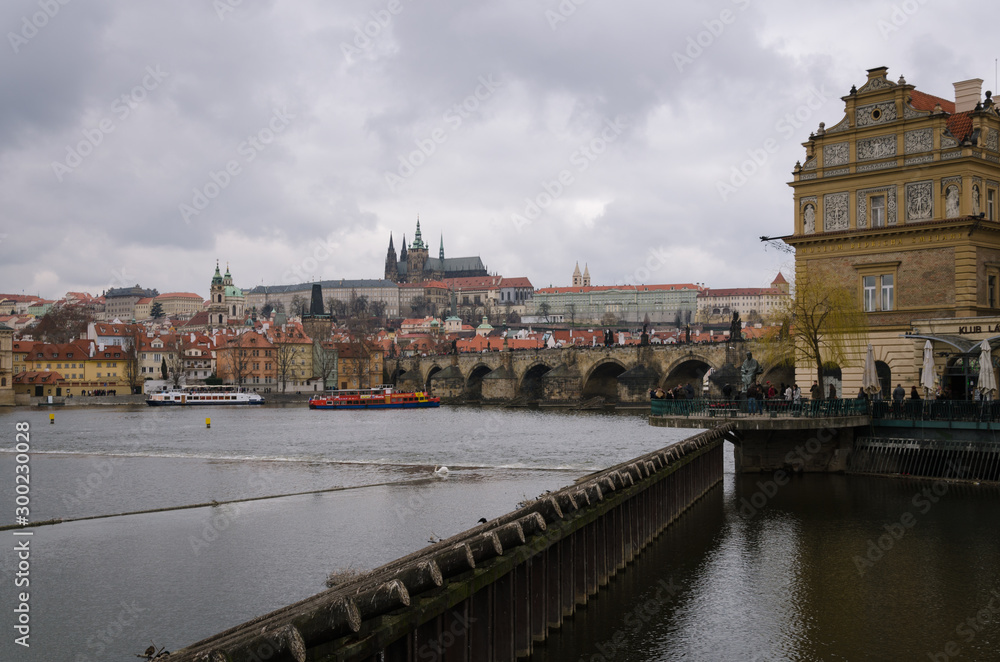 Cityscape of Prague with the Charles bridge and the cathedral in a cloudy day, Prague, Czech Republic