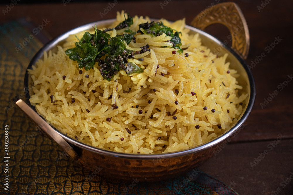 Indian lemon rice pilaf served in copper bowl Indian lemon rice pilaf served in copper bowl