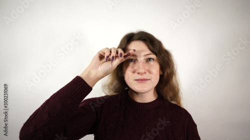 Close-up of woman use hand rubbing her eye with sleepy face. Concept of health care and medical. photo