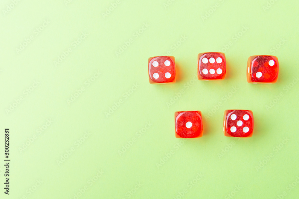 Red dice lying on a green background Red dice lying on a green background