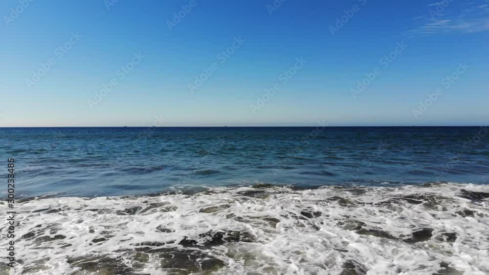 Seaside wave of a beach seen from a front view Seaside wave of a beach seen from a front view