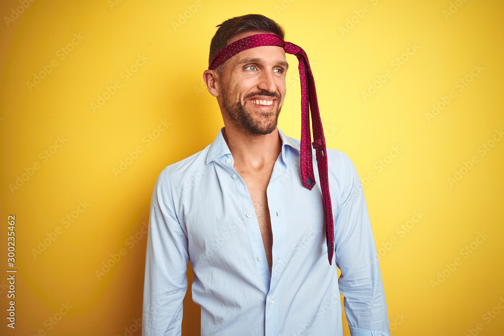 Hangover business man drunk and crazy for hangover wearing tie on head looking away to side with smile on face, natural expression. Laughing confident. Hangover business man drunk and crazy for hangover wearing tie on head looking away to side with smile on face, natural expression. Laughing confident.